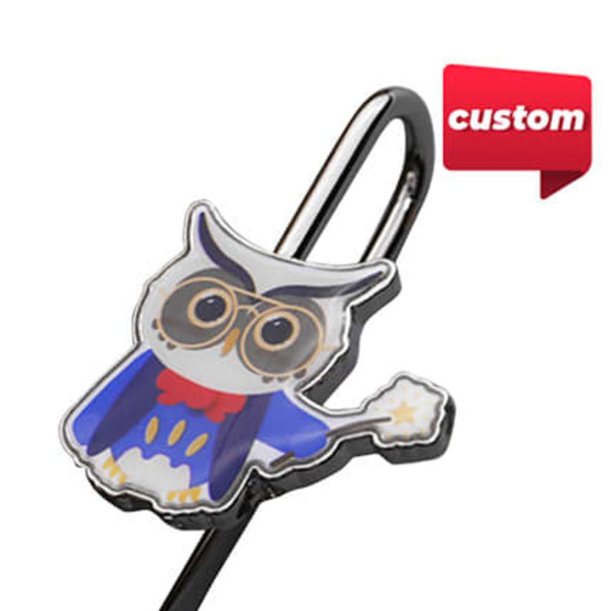 A metal bookmark featuring a colourful owl design with glasses, attached to a silver clip.