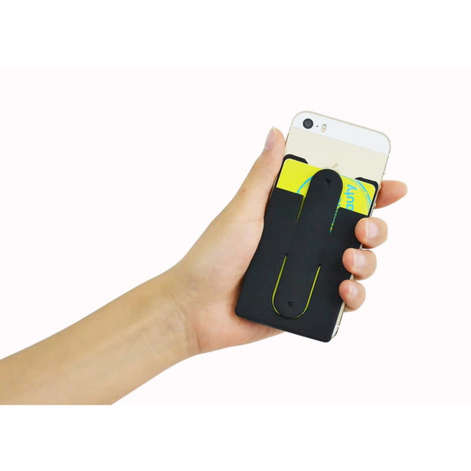 A black phone wallet stand is held in a hand, attached to the back of a smartphone, with cards inserted.