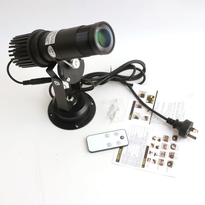 A 25W advertising LED logo projector light in black with a remote control and installation instructions.