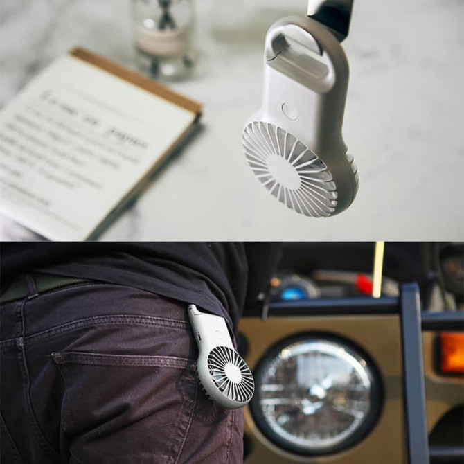 A mini fan in white with a built-in LED light, attached to a carabiner, displayed against various backgrounds.