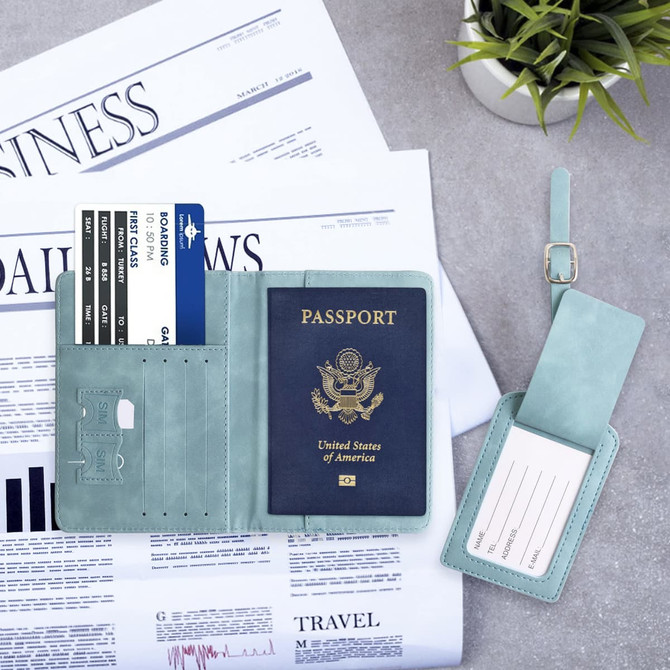 A teal multifunctional PU leather passport holder with slots for cards and a detachable luggage tag on a grey surface.