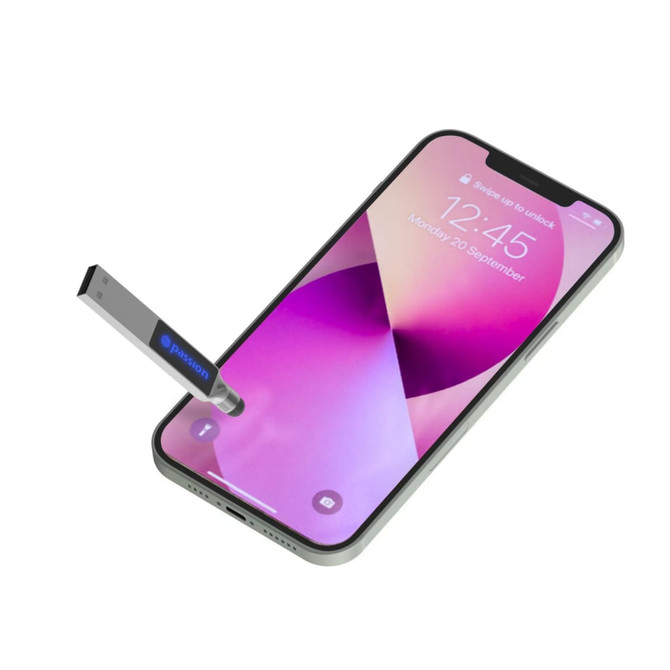 A silver stylus and backlit logo flash drive next to a smartphone displaying a vibrant screen.