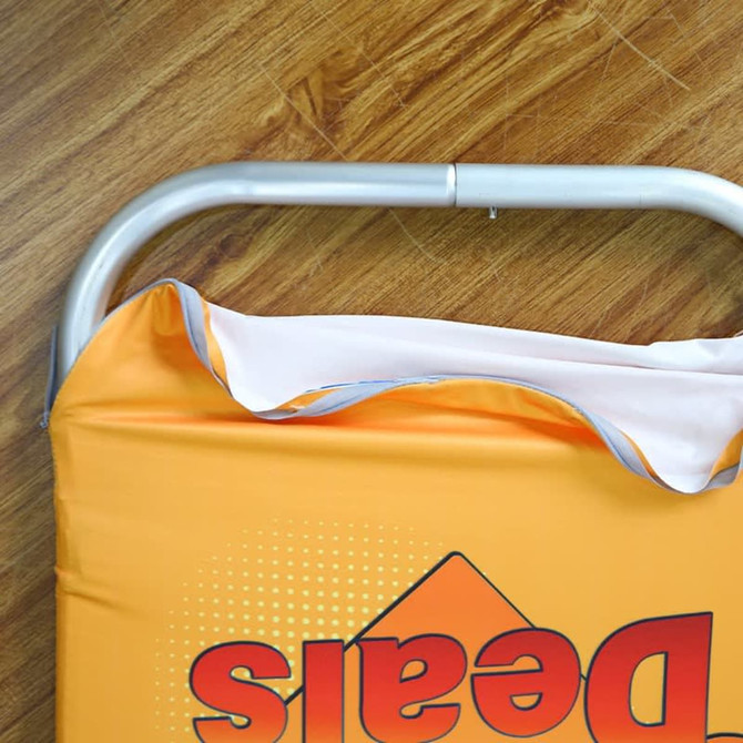 An orange table top banner with an aluminium frame, showcasing a fold-over design.