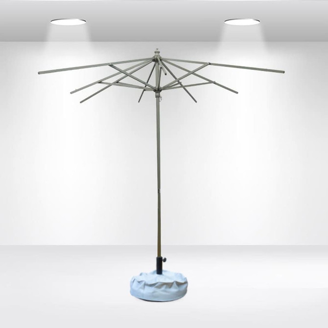 A square patio umbrella with valances, featuring a grey frame and blue base, positioned in a well-lit indoor setting.