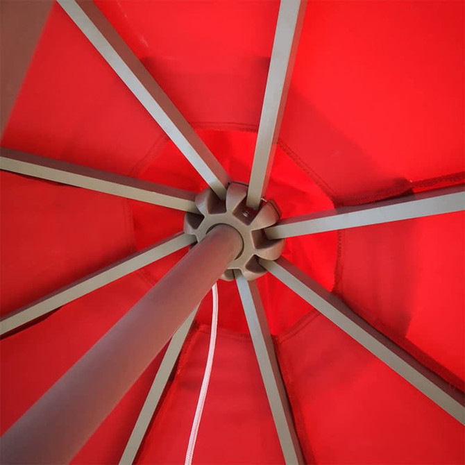 A red patio umbrella with a sturdy metal frame, viewed from underneath, showcasing its structure.