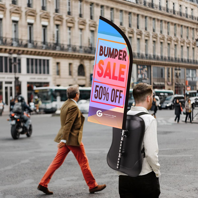 A backpack with a black base and a colourful feather flag attached, prominently displaying a promotional message.