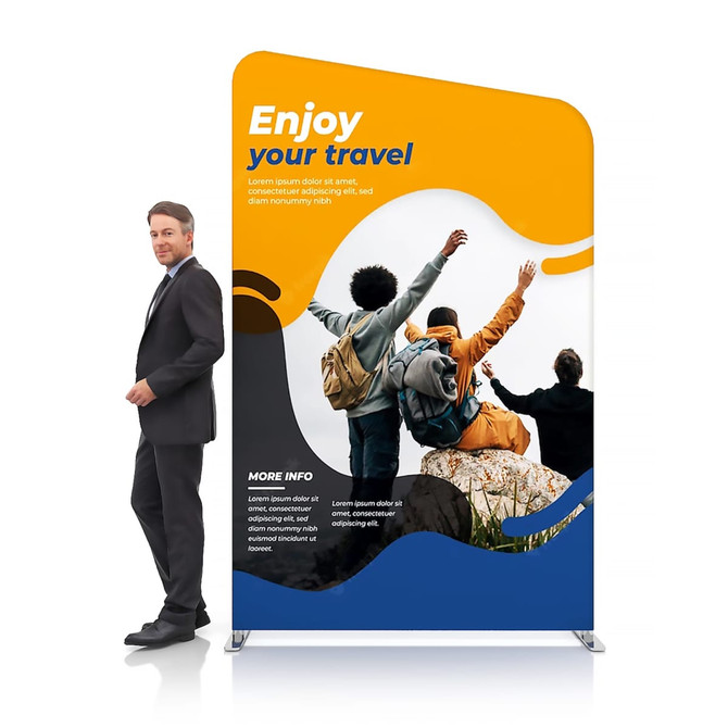 Inclined portable exhibit display wall in bright yellow and blue, featuring people celebrating travel. A person stands beside it.