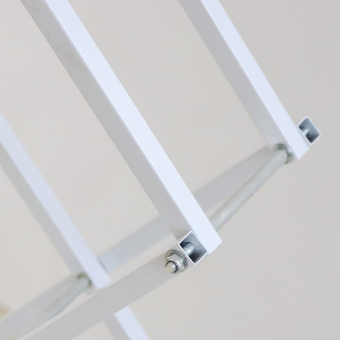 A white metal frame with visible joint mechanisms, designed for a display stand.