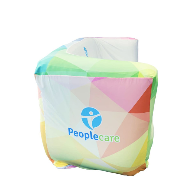 An inflatable two-seat sofa in a vibrant, multi-coloured design with a logo.