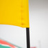 A yellow flag featuring a black pole, part of a larger promotional banner display.
