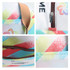 A colourful waterproof RPET cooler bag with a zipper and leather handle, featuring a vibrant geometric design.
