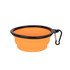 An orange collapsible silicon bowl with a black rim and a carabiner clip.