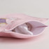 A hot water bottle in white, nestled inside a pink plush cover featuring a cute design.