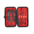 A black manicure set with red lining, featuring scissors, clippers, and various grooming tools in a compact case.