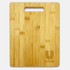 A bamboo chopping board with a handle, featuring a subtle logo in the corner. It has a natural wood finish.
