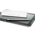 A silver metal pen rests on a tablet, next to its white packaging featuring a logo.