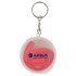 A clear container with a keyring holds a red reusable silicone straw inside. The container features a logo.