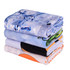 A stack of four gym towels in various colours, featuring designs including ice, abstract patterns, and solid hues.