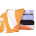 A stack of colourful gym towels featuring orange, black, blue, and white designs, with branding visible on one towel.