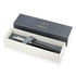 A metal ballpoint pen in matte black, presented in a stylish box with a logoed lid and grey cushioning.