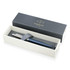 A matte blue ballpoint pen in a grey and white box, featuring a logo.