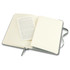 A medium-sized Moleskine classic hard cover notebook in grey, opened to reveal blank pages and a text insert.