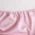 A pink rectangular table topper with a gathered edge, designed to cover a 6ft table. It has a soft fabric texture.