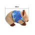 A brown wombat plush toy with a blue patterned scarf, measuring 26cm in length. Features a logo on the scarf.