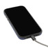 A black smartphone with a textured case and a grey charging cable connected.