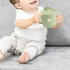 A drink bottle in soft green silicone, featuring a lid with a straw and a logo, held by a smiling child.