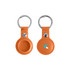 An orange PU leather AirTag holder with a keyring, featuring a logo on one side.
