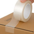 A clear BOPP packing tape being applied to a brown cardboard box. The tape is partially unrolled, showing its glossy finish.