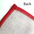 A close-up of a custom polyester tea towel with a red hem, showcasing the back texture.