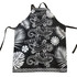 A black polyester apron featuring white lizard designs and tropical foliage patterns, complete with ties and a logo.