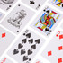 A set of playing cards featuring various designs and symbols in red, black, and multicoloured patterns.