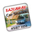 A square fridge magnet featuring a car under a shade structure, with a logo and contact details in bold text.