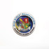 A circular stainless steel lapel pin featuring a logo with various colours, including blue, red, and green.