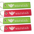 A set of woven keyrings in red and green, featuring a logo and text. Each keyring includes a metal keyring attachment.