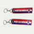 A red and blue woven keyring with the word "CROATIA" and a logo. It has a metal keychain attachment.