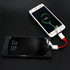 A 4 in 1 USB charging cable in red, connecting two smartphones, with one device displaying a charging status.