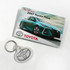 A promotional folder featuring a blue 2017 Toyota Prius and a silver key tag. The folder has a logo.
