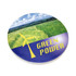 A round, absorbent stone coaster featuring a wind turbine and green fields, with blue and yellow colour accents.