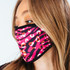 A fabric face mask in pink and black with a leopard print design, featuring elastic ear loops and a logo.