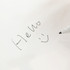 A5 whiteboard notebook featuring a handwritten note and smiley face, with a black marker on a white background.