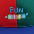 A multi-coloured baseball cap featuring an embroidered logo. The colours include red, green, and blue.