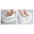 A white step stool with textured surface and a logo, being used with bare feet on a tiled floor.