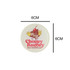 Acrylic fridge magnet featuring a playful design with a bakery theme, primarily in white, red, and brown.