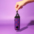 A neoprene golf ball sleeve in purple with a pattern, featuring a strap for easy carrying.