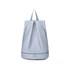 A light blue backpack with a handle and zippered compartments featuring a logo.