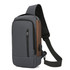 A grey and brown anti-theft sling bag with a zippered pocket and adjustable shoulder strap. It features a logo.